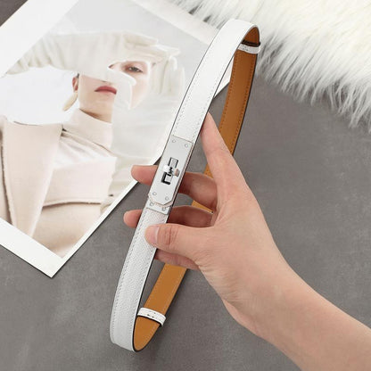 A sleek white Epsom leather Kelli belt featuring a polished silver-tone turn-lock plate and tan leather lining
