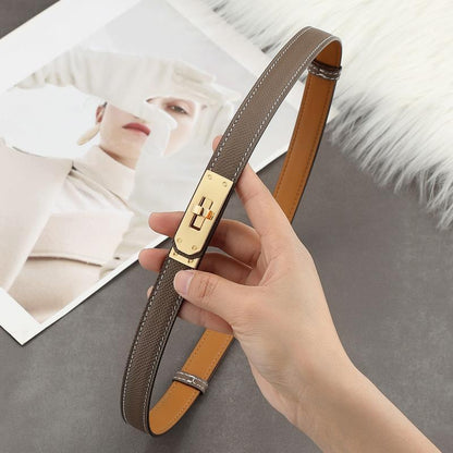 Close-up of an Etoupe Epsom leather Kelli belt featuring white contrast stitching and a polished golden turn-lock hardware.