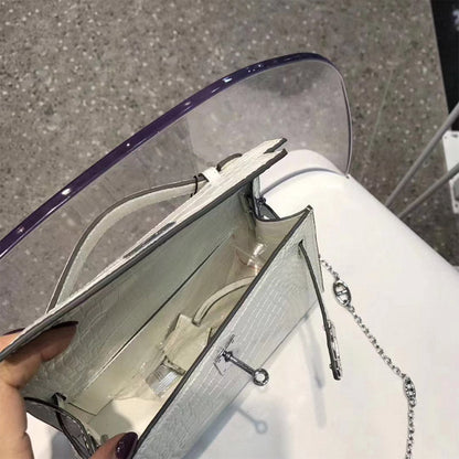 Interior view of white crocodile embossed leather Kelli clutch showing main compartment.