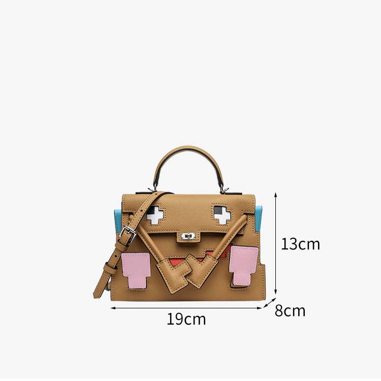 Mini Picto Kelly Doll bag in tan Epsom leather featuring a pixelated face, top handle, and adjustable shoulder strap (19 x 8 x 13 cm).