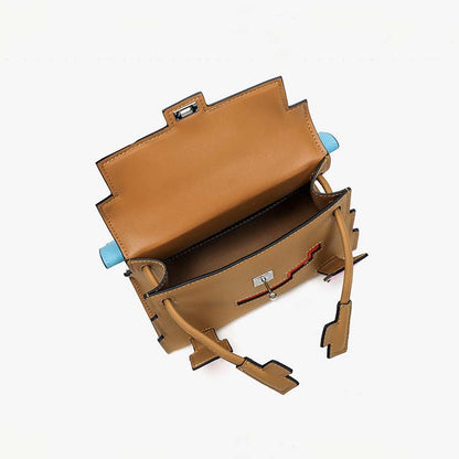 An interior view of the Khaki Leather Picto Kelly Doll bag, showcasing its spacious interior, swivel clasp details, and playful arm-shaped top handle.