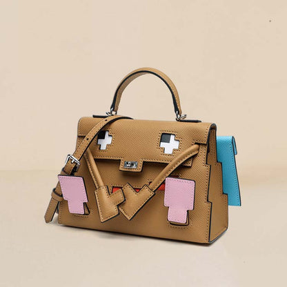 An interior view of the Chai Leather Picto Kelly Doll bag, showcasing its spacious interior, swivel clasp details, and playful arm-shaped top handle.