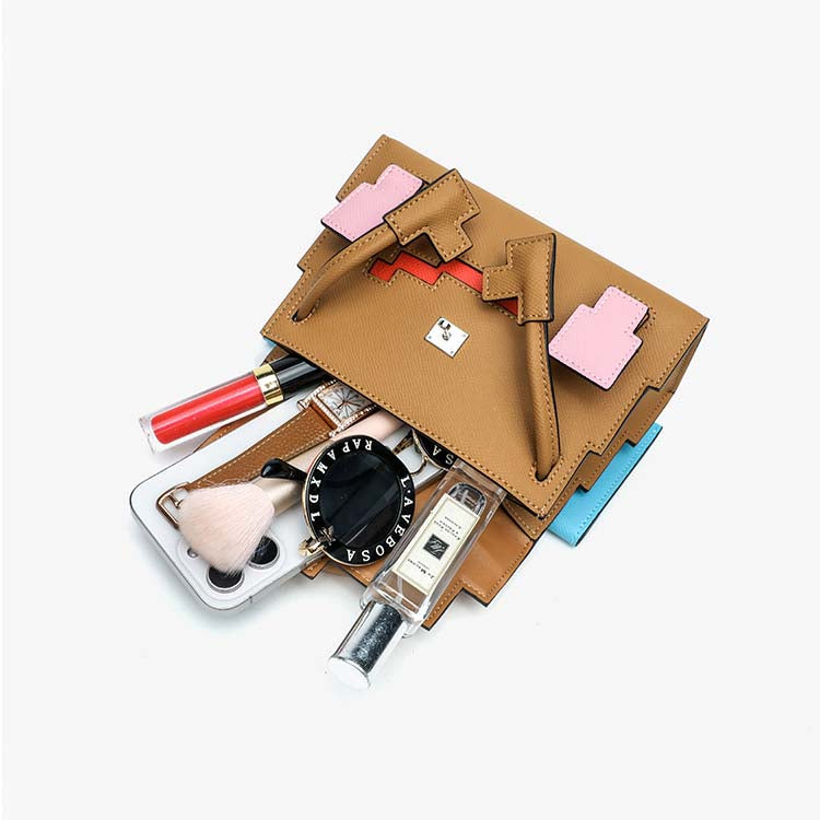 Open Picto Kelly Doll bag displaying interior capacity with smartphone, perfume, and makeup essentials.
