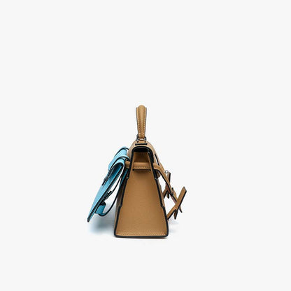 Side profile of tan Picto Kelly Doll bag showing its structured silhouette and the attached blue mini backpack.
