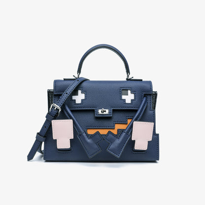 Dark Blue Epsom leather Picto Kelly Doll bag with pixelated face design, tan accents, and a matching shoulder strap.