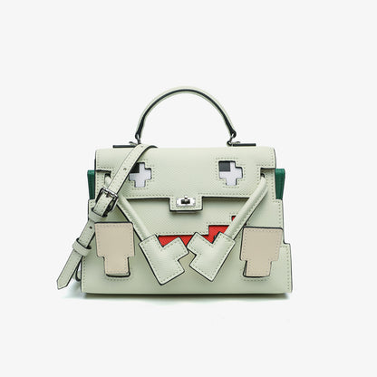 Grass Green Epsom leather Picto Kelly Doll bag with pixelated face design, tan accents, and a matching shoulder strap.