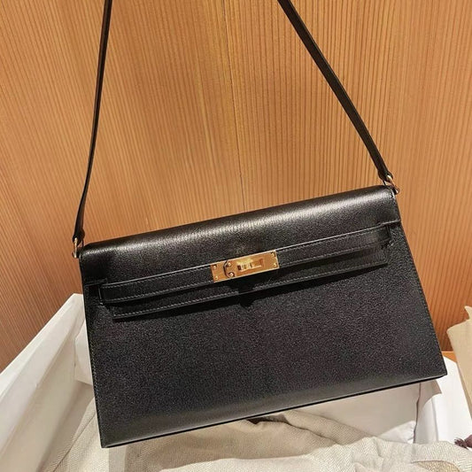 Black Epsom leather inspired Kelly Elan shoulder bag with gold hardware and removable strap.