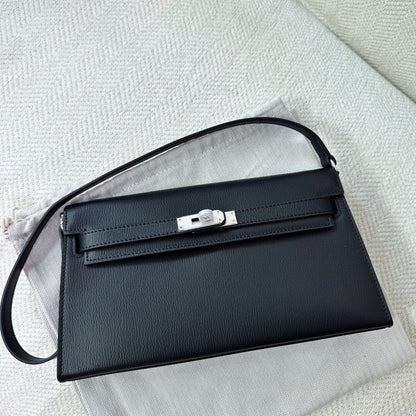 Black split leather inspired Kelly Elan shoulder bag with silver-tone hardware on a white dust bag.