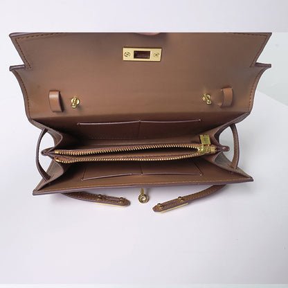Interior view of an open tan inspired Kelly to go wallet in cowhide leather, showing a central zippered pocket, two gusseted compartments, and multiple card slots.