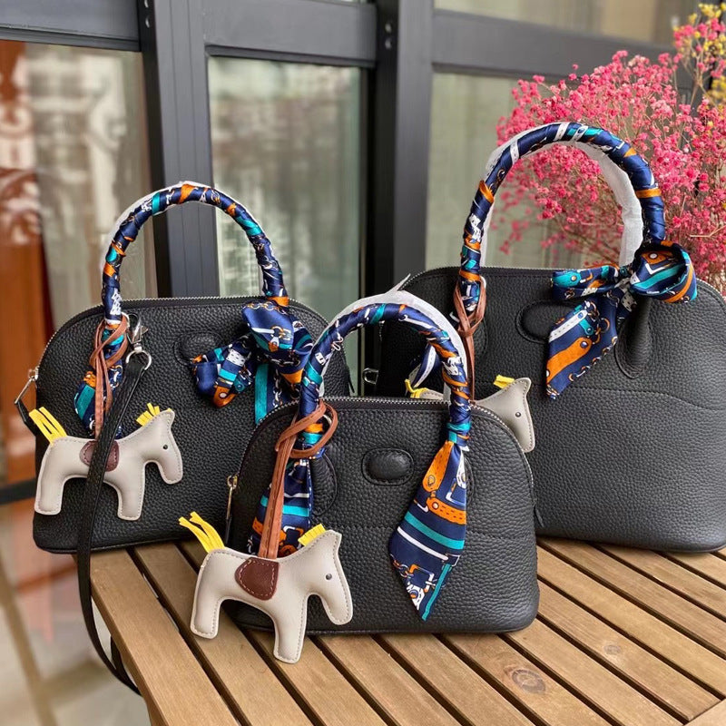Three sizes of black leather bowling shell bags comparison with silk scarves