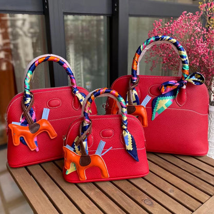 Three sizes of red leather bowling shell bags comparison with silk scarves