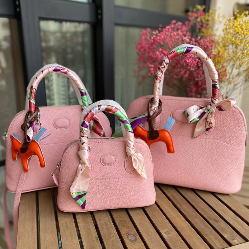 Three sizes of pink leather bowling shell bags comparison with silk scarves