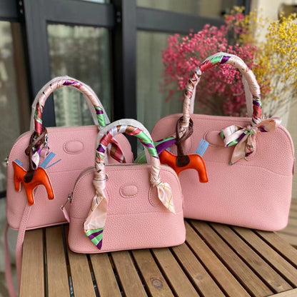 Three sizes of pink leather bowling shell bags comparison with silk scarves