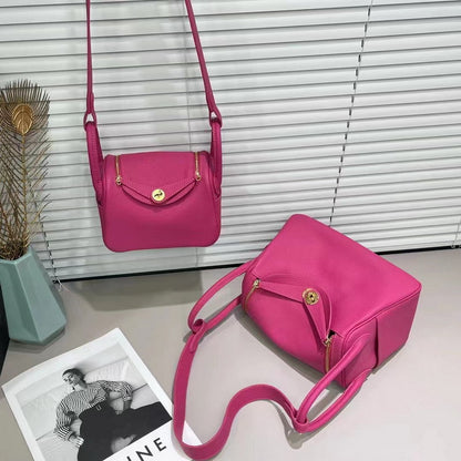 Raspberry red top grain leather Lindy bag with golden hardware and shoulder strap