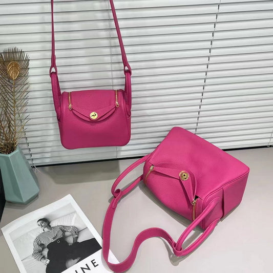 Raspberry red top grain leather Lindy bag with golden hardware and shoulder strap