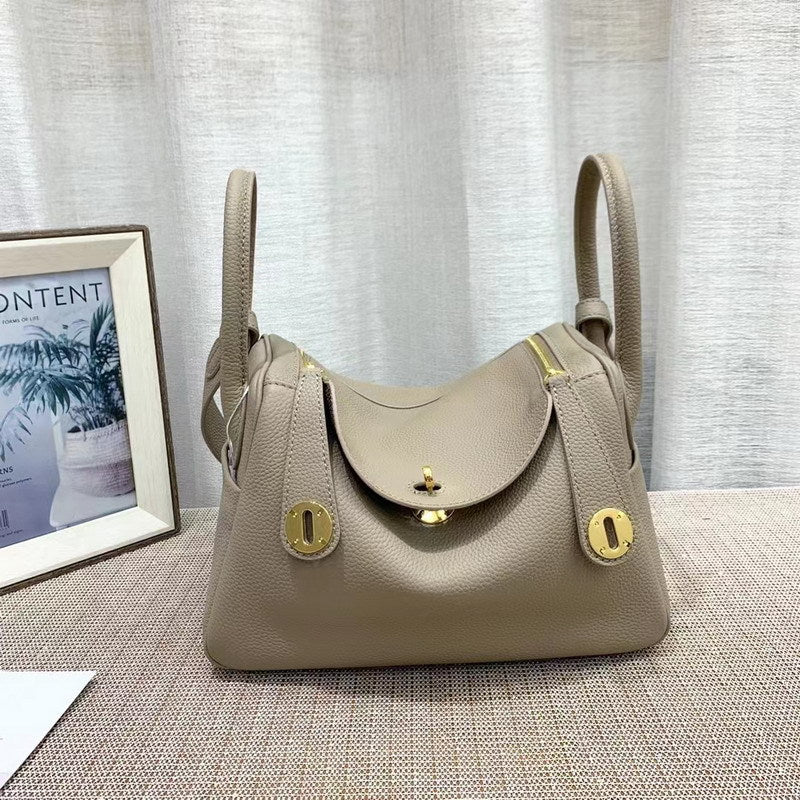 Gray top grain leather Lindi bag with golden hardware and dual zippers
