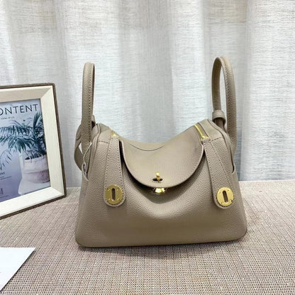 Gray top grain leather Lindi bag with golden hardware and dual zippers