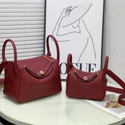 Angolan red top grain leather Lindy bags in two sizes with golden hardware
