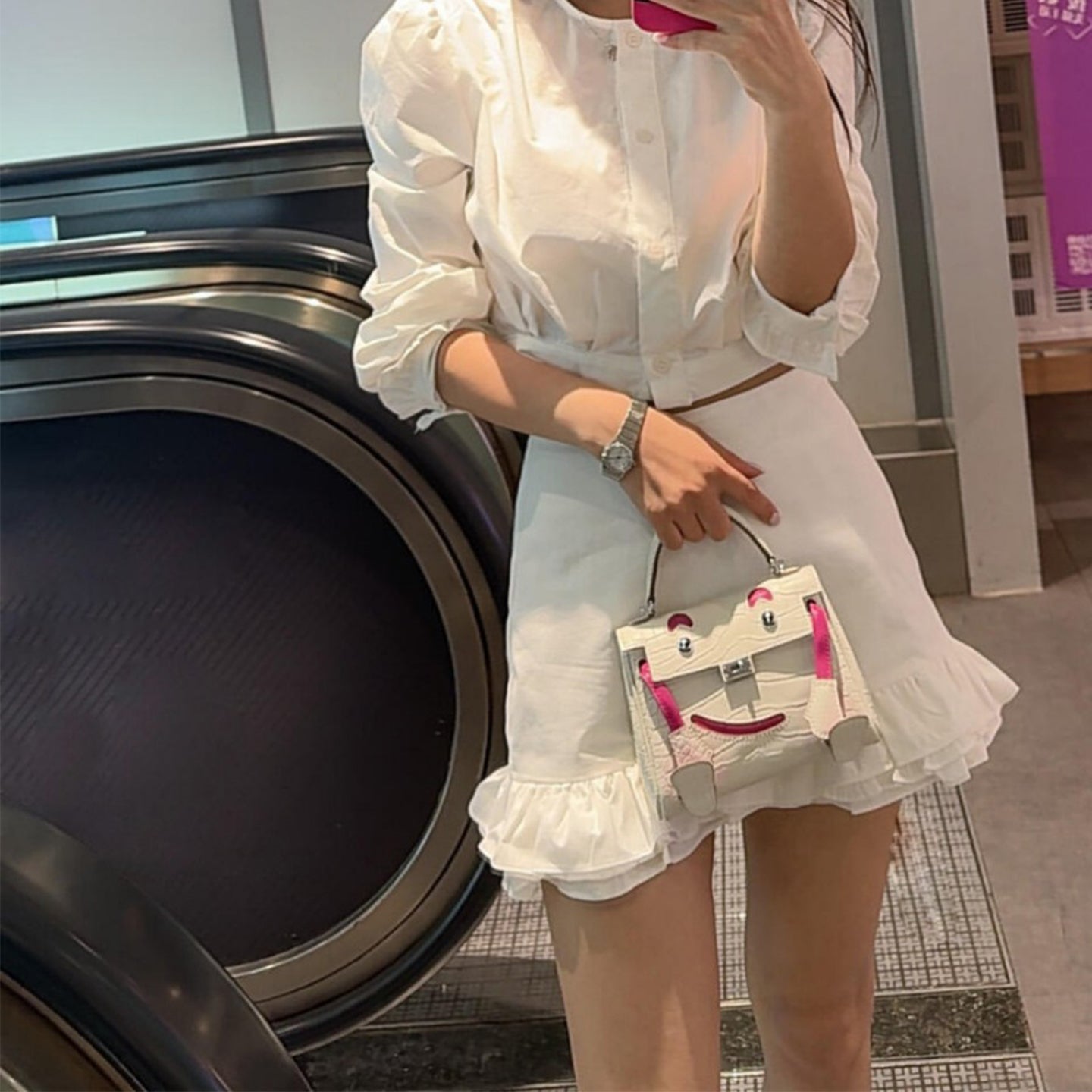  Lifestyle shot of the mini leather doll bag, perfect for chic and quirky summer outfits.