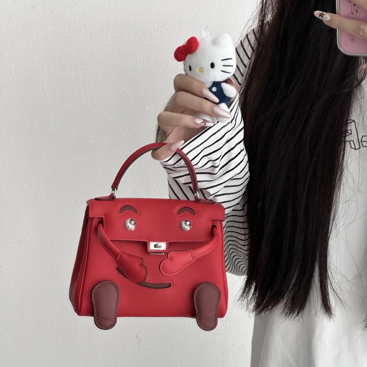  Statement red leather doll bag with unique character features and top handle.
