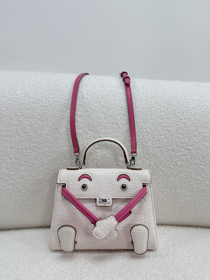  Unique white and pink croc-embossed leather doll bag with adjustable limbs and top handle.