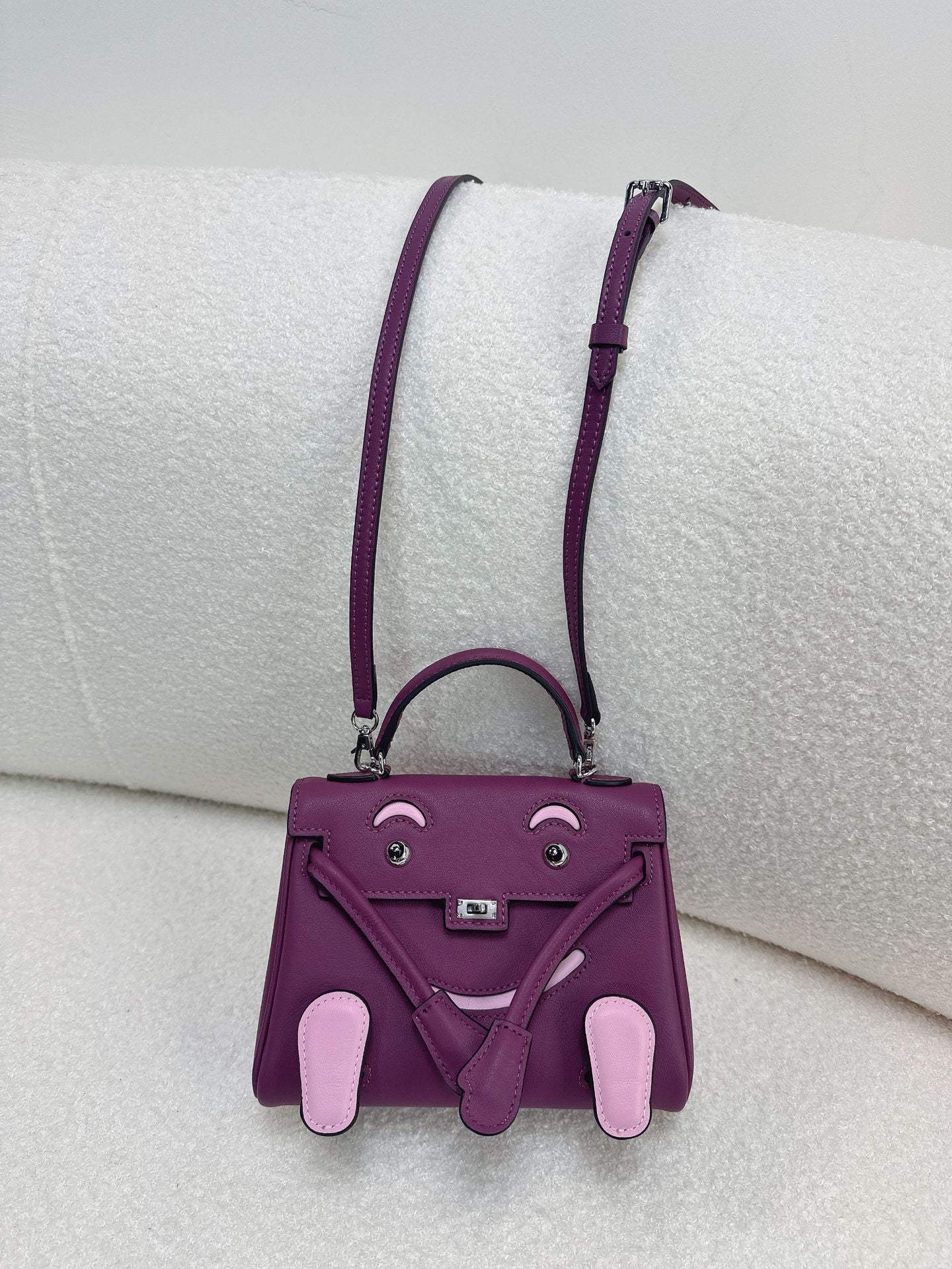  Unique purple and pink leather doll bag with adjustable strap for a trendy, artistic look.