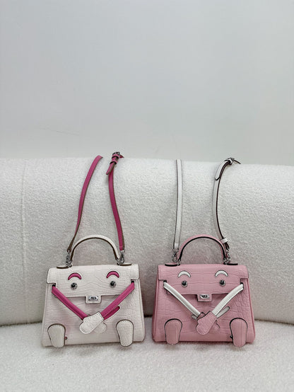  Chic croc-embossed leather Kelli Doll bags in vibrant pink and white colorways with adjustable straps.
