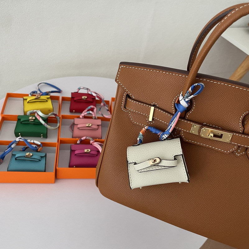 Mini Kelli handbag charm and vegan leather earphone case for AirPods Pro 2 in various colors.