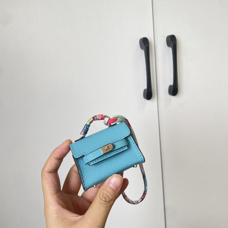 Peacock Blue Mini Kelli bag charm with a silk scarf handle.