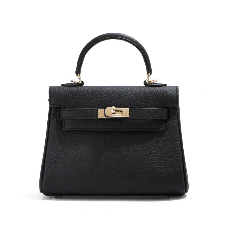 Front view of a black mini Kelli handbag in premium pebbled leather with elegant gold hardware.