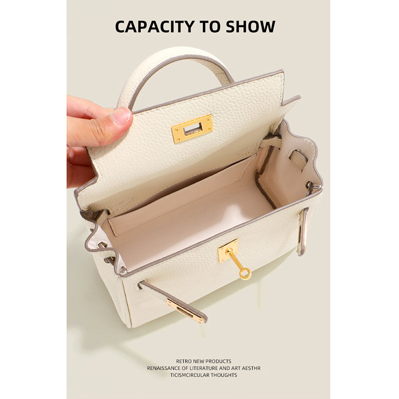 Interior view of a Milkshake White mini Kelli handbag showing the spacious main compartment and gold hardware details.