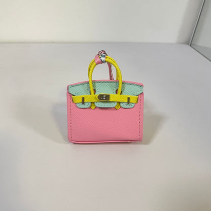 Tri-color pink, yellow, and light blue mini Birkin bag charm with silver hardware.