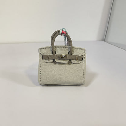 Two-tone gray and dark gray mini Birkin bag charm with silver hardware.