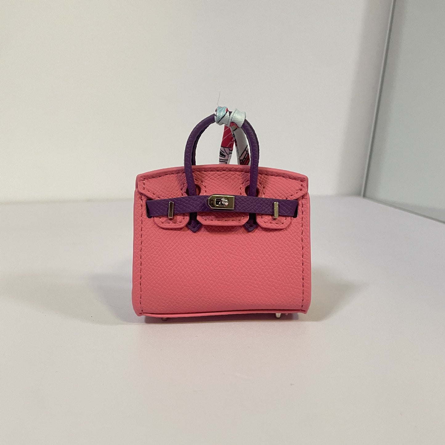 Two-tone watermelon red and purple mini Birkin bag charm with silver hardware.