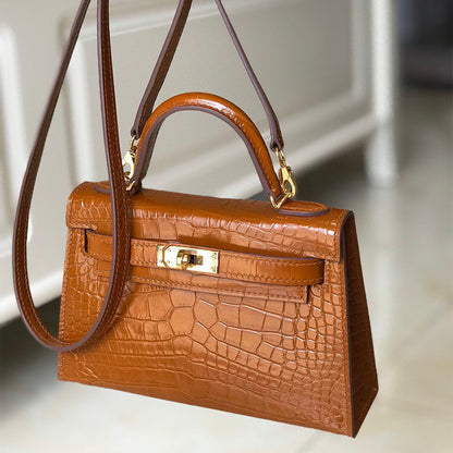 Gold Brown croc-embossed leather mini Kelly handbag with gold-tone hardware and top handle.
