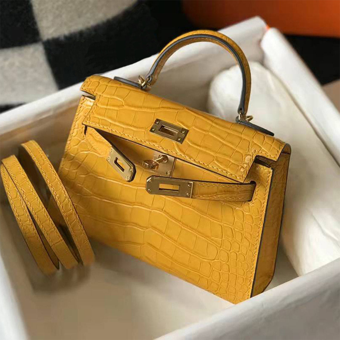 Yellow croc embossed leather mini Kelly bag with gold hardware and matching shoulder strap in a box.