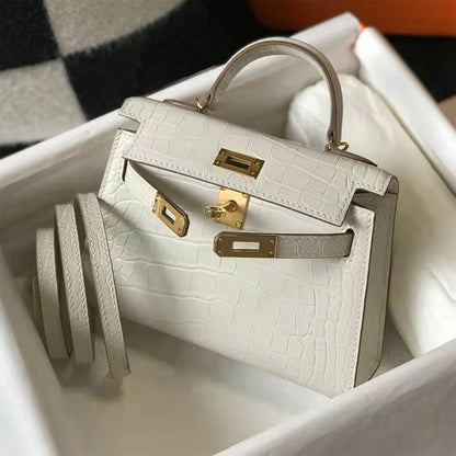 Cream white croc embossed leather mini Kelly bag with gold hardware and rolled shoulder strap in a gift box.