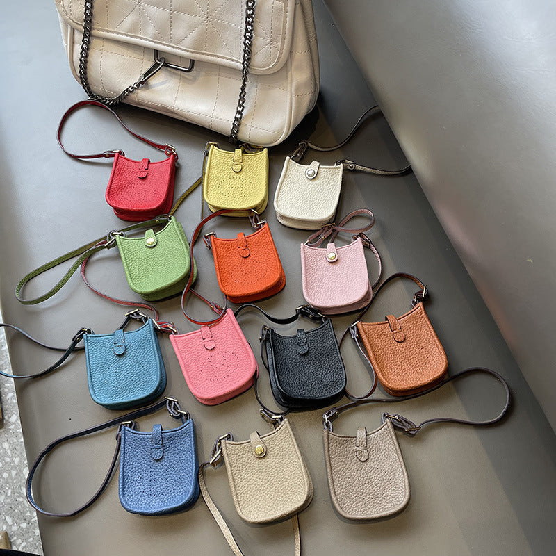 Colorful mini leather bag charms collection as stylish handbag accessories and AirPods holders.