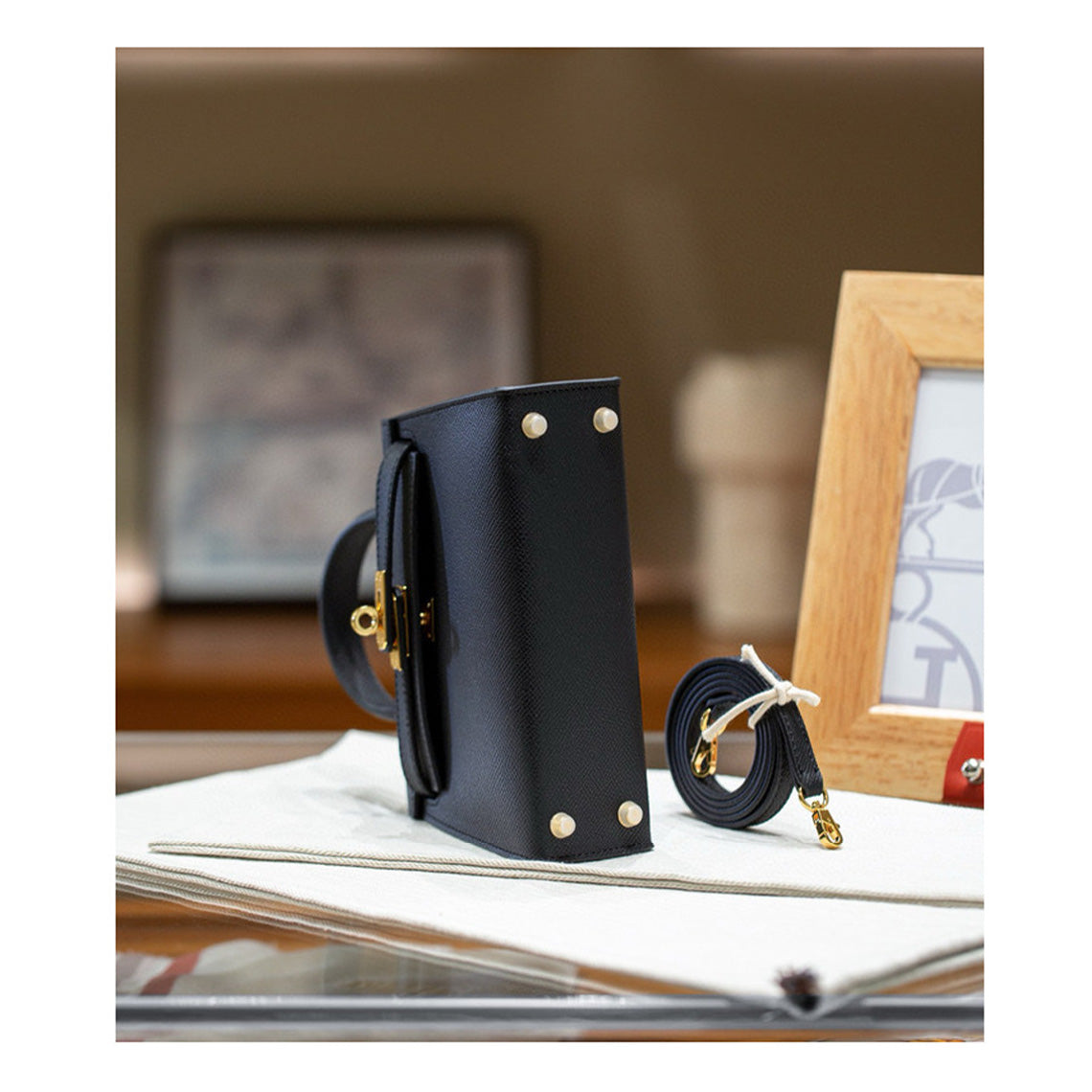 Black leather kelly handbag with a strap