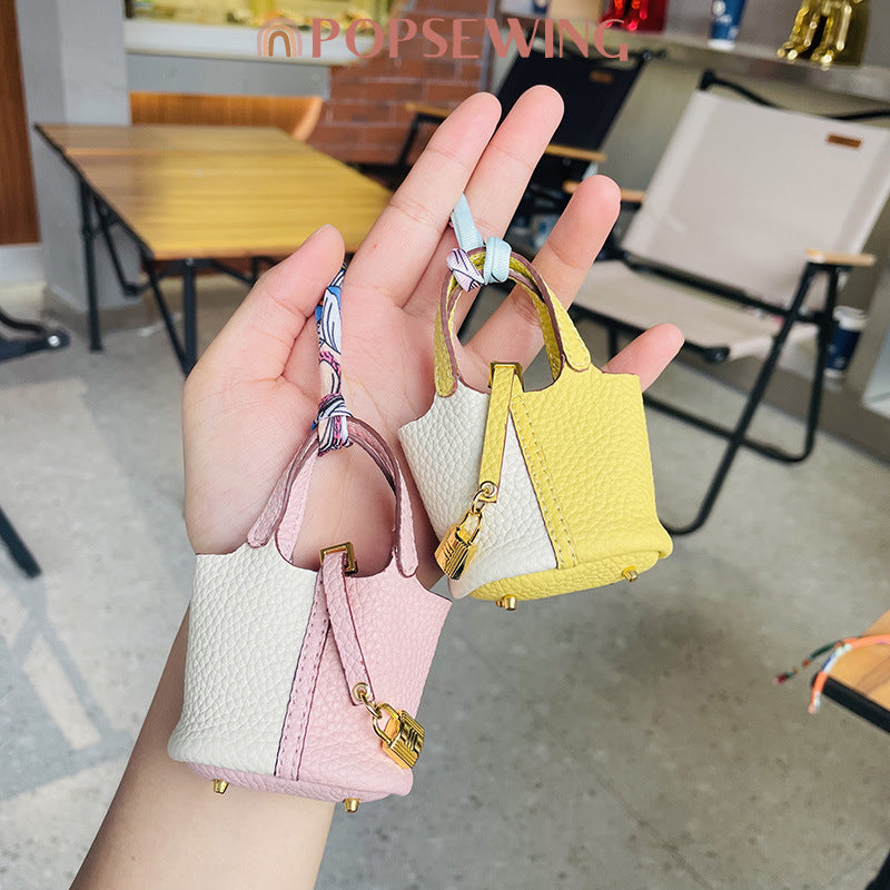 Two-tone pink and yellow mini Picotin leather bag charm AirPods holder with silk ribbon.