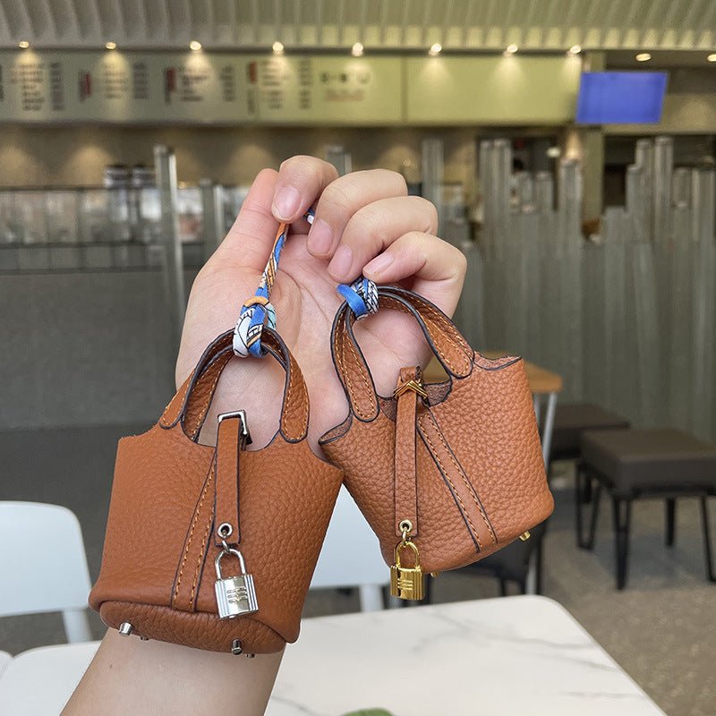 Brown mini leather Picotin bag charms with silk ribbon and lock detail.