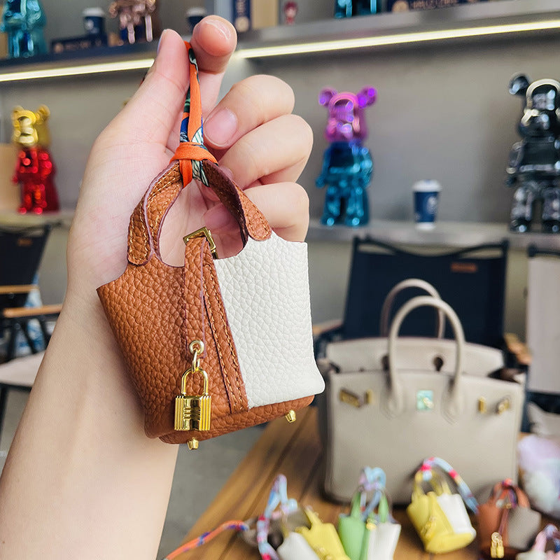 Two-tone brown and white mini leather Picotin bag charm with gold lock.