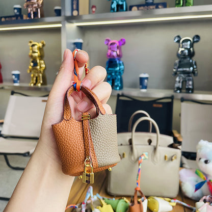 Two-tone brown and grey mini leather Picotin bag charm with gold lock .