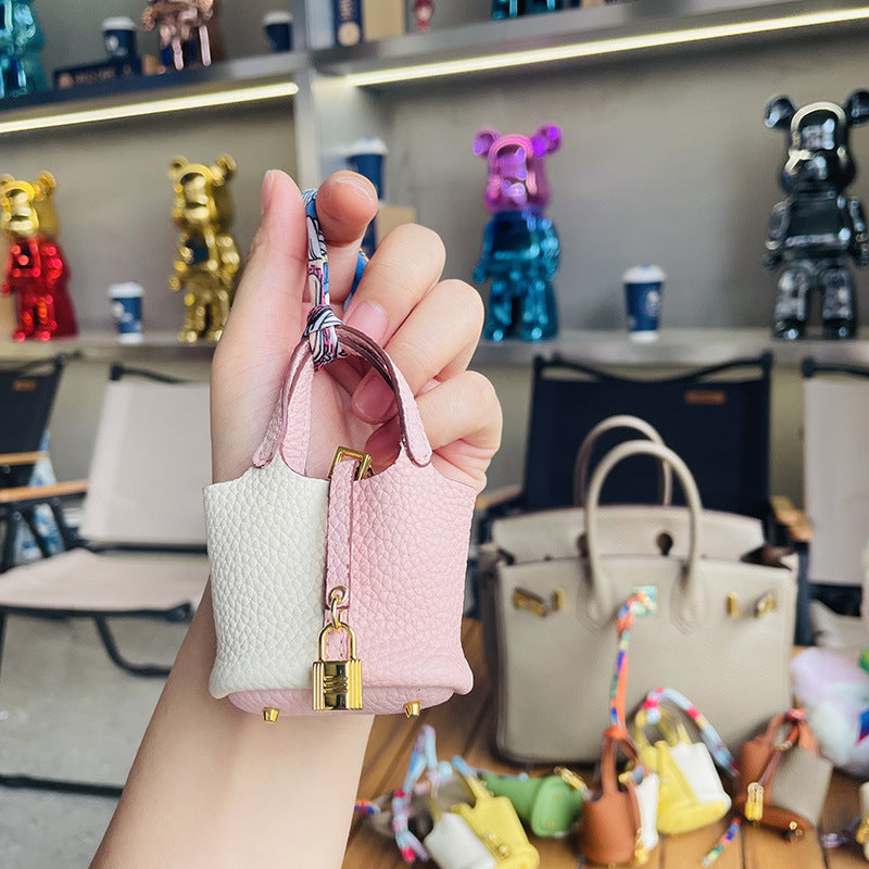 Two-tone pink and white mini leather Picotin bag charm with gold lock .