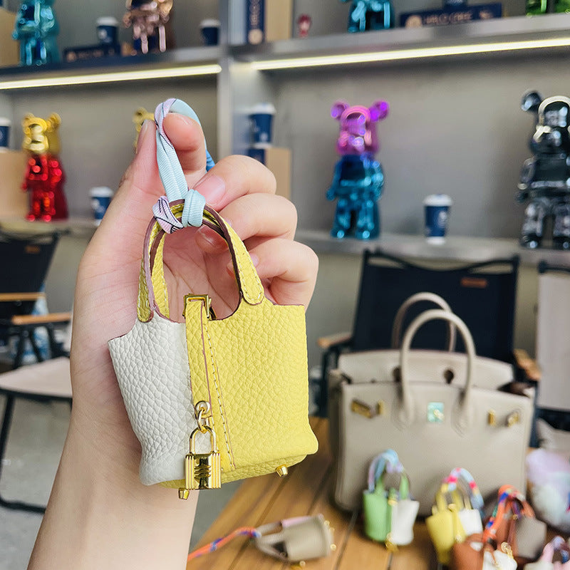 Two-tone yellow and white mini leather Picotin bag charm with gold lock.