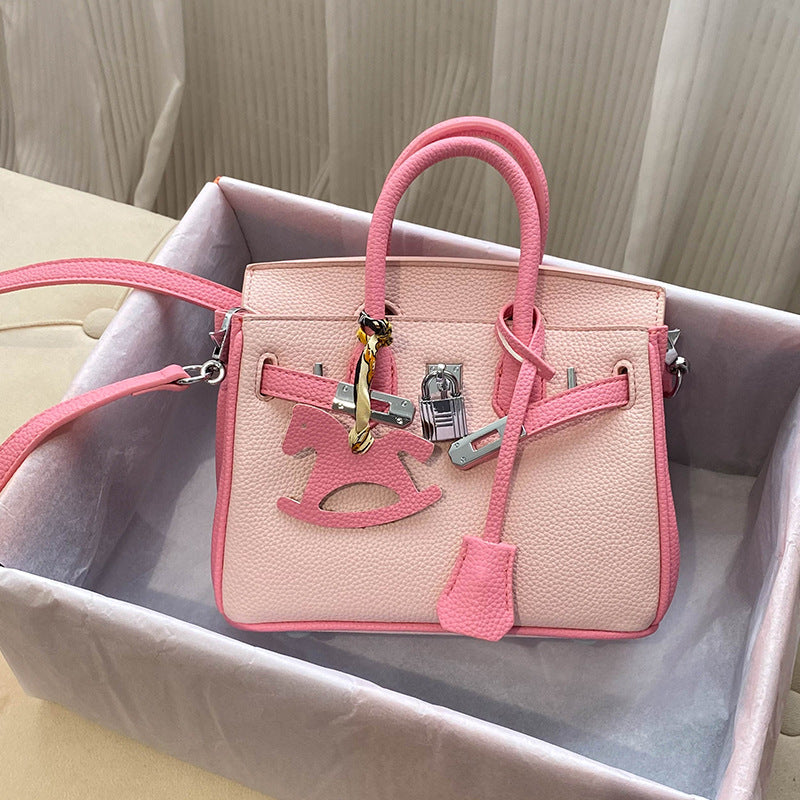 Front view of a bi-color Pink and Rose Pink inspired Birkin handbag in cow split leather, featuring double rolled handles and a signature silver twist lock.