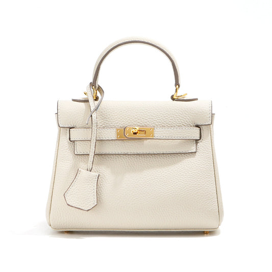 Front view of a white mini Kelli handbag in top grain leather with gold hardware.