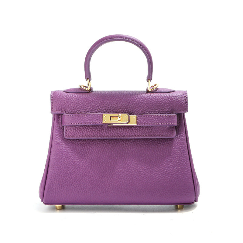 Front view of a purple mini Kelli handbag in premium top grain leather with elegant gold hardware.