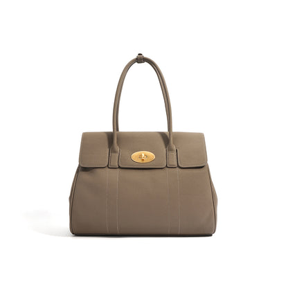 Taupe pebbled top grain leather tote bag with gold twist lock and dual top handles.