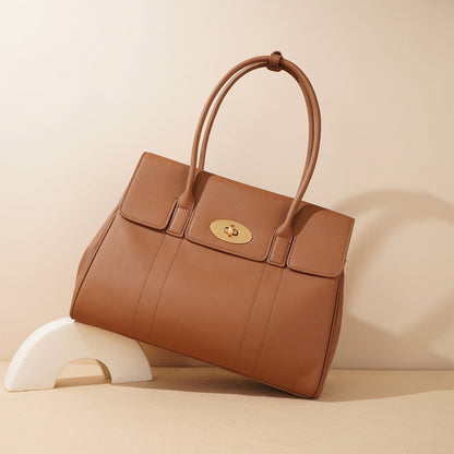 Elegant brown pebbled leather tote bag displayed as a luxury fashion accessory.